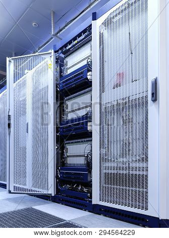 Technical Wall Of Cellular Data Terminal Rows With Opened Mesh Door.