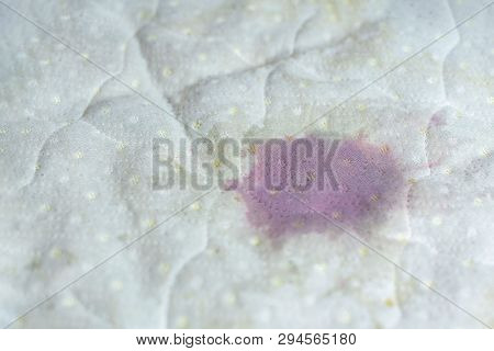 Wet Stain Of Spilled Red Wine On Bed. Red Wine Stain On White Bed Sheet. Unlucky, Unfortunate Incide