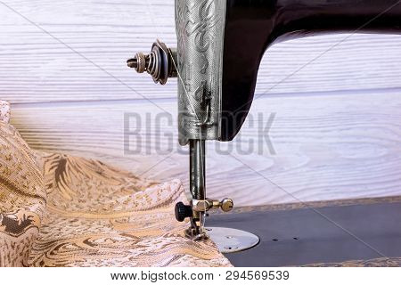 Sewing Head Of Antique Sewing Machine With Presser Foot During Hemming Close Up