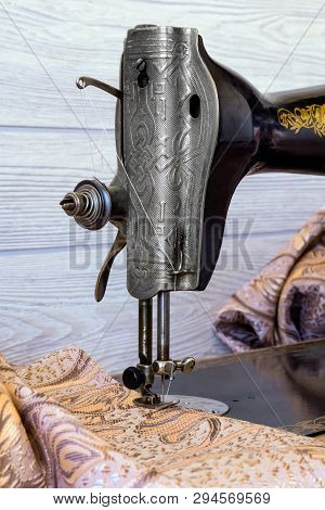 Sewing Head Of Antique Sewing Machine With Presser Foot During Hemming Close Up, Vertical Frame