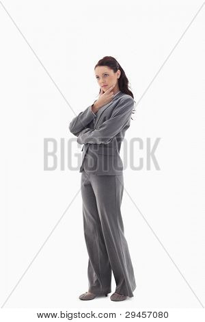 Profile of a businesswoman with the hand on her chin looking at the top against white background
