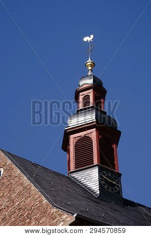 The Clock Tower And The Steeple Of The Catholic Church St. Martin In Eddersheim In Sunlight.
