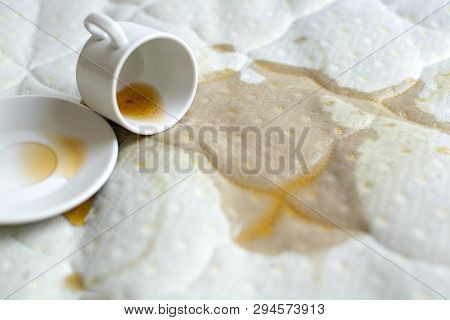 Spilled Coffee On The Bed. Unlucky, Unfortunate Breakfast. Accidentally Dropped Cup With Saucer On W