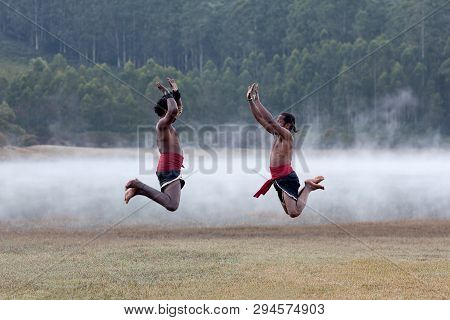 Indian Fighters Jumping Up During Kalaripayattu Marital Art Demonstration In Kerala, South India
