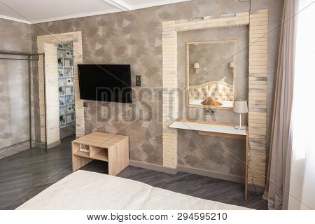 Fragment Of The Interior Of A One-room Apartment With A Tv And Dressing Table