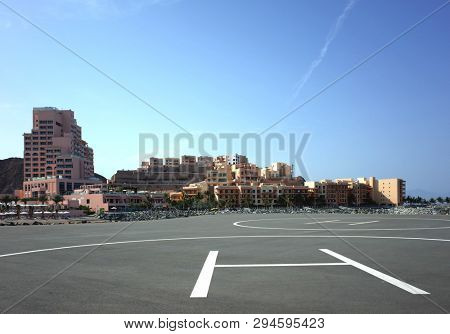 Dibba Al-Fujairah, Fujairah, UAE - April 4, 2019: Helicopter parking in front of Fairmont Fujairah beach resort and Mina Al Fajer