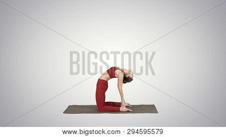 Sporty Beautiful Young Woman Practicing Yoga, Doing Ushtrasana, Camel Pose On Gradient Background.