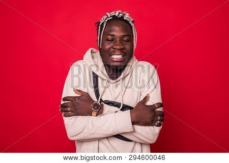 Handsome African Man Freezing Isolated On Red Background
