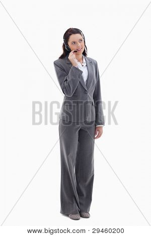 Businesswoman listening with a headset against white background