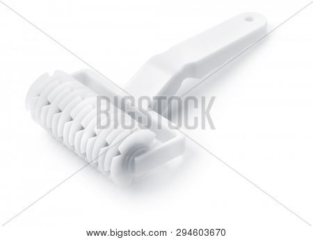 Plastic lattice dough cutter roller isolated on white