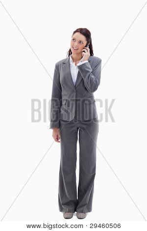 Businesswoman on the phone looking up against white background