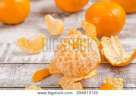 Peele Dripe Tangerines On Wooden Light Background