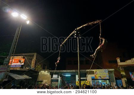 Kolkata, West Bengal, India - 15 April 2018: Two Hindu Devotees Are Hanging From Pole In Air, At Nig