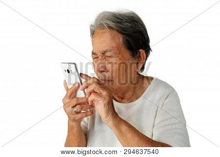 Elderly Asian Woman Are Holding And Looking Mobile Phone With Poor Eyesight Isolated On White Backgr