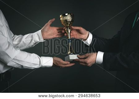 Award Ceremony Concept. Businessman Is Giving A Golden Cup Award Trophy To A Winner. First Place Bac