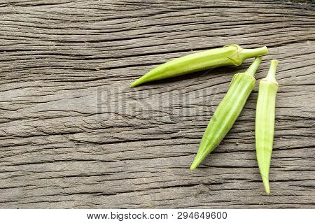 Fresh Green Okra On Wooden Floor - Abelmoschus Esculentus