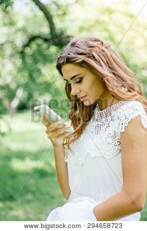 Beautiful Young Bride Chating By Mobile Phone During Wedding.