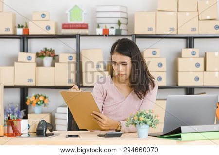 Shot Of Young And Beautiful Asian Business Lady In Casual Fashion Dress, Rechecking Purchase Order L