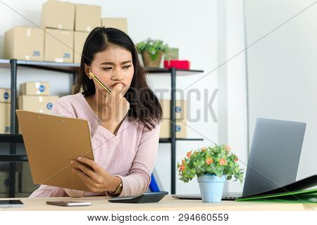Shot Of Young And Beautiful Asian Business Lady In Casual Fashion Dress, Rechecking Purchase Order L