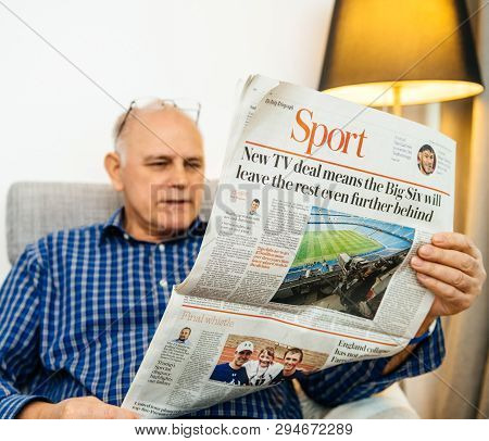 Paris, France - 29 Mar 2019: Curious Senior Man Reading In Living Room Latest British The Daily Tele
