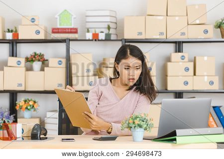 Shot Of Young And Beautiful Asian Business Lady In Casual Fashion Dress, Rechecking Purchase Order L