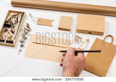 Envelop, Label, Bag, Paper And Other Office Suplies On A White Desk