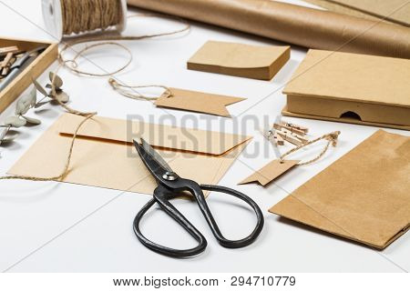 Envelop, Label, Bag, Paper And Other Office Suplies On A White Desk