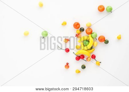 A Scattering Of Many Small Different Fruits On A White Background. Mini Copy, The Concept Of Diversi