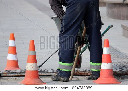 Road Work And Construction, The Worker Of Municipal Services Repairs Drainage System. Wastewater Tre