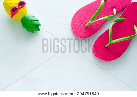 Pink Beach Flip Flops  And Squishy Toy Pineapple In Sunglasses On White  Background Copy Space