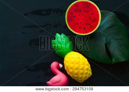 Top View Monstera Green Leaf ,flamingo ,pineapple And Watermelon Squishy Toy On Blackboard Copy Spac