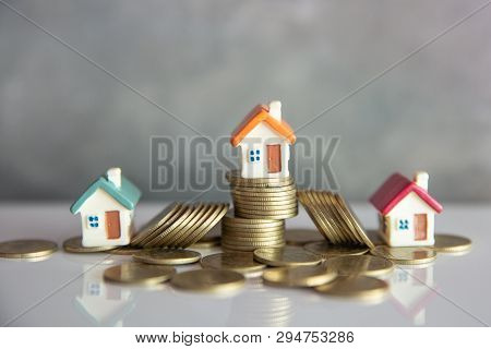 Mini House On Stack Of Coins,money And House,  Mortgage, Savings Money For Buy House And Loan To Bus