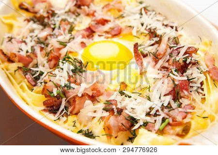 Breakfast. Scrambled Eggs With Bacon, Meat, Grated Parmesan Cheese, In Ceramic Ware, On A Wooden Sta