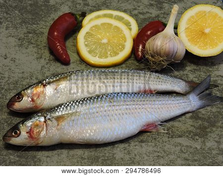 Two Raw Fish And Lemon. Mullet Lemon Garlic.