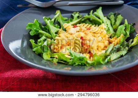 Salad made from radiatori cooked pasta, goat cheese and oil vinaigrette