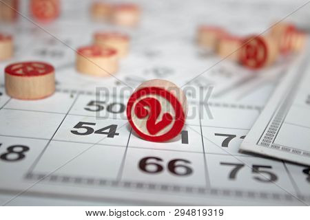 Bingo Or Lotto Game. Wooden Kegs Of Lotto On Cards. Cards And Chips For Playing Bingo On A White Tab