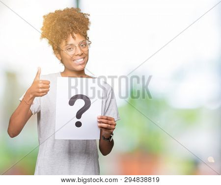 Young african american woman holding paper with question mark over isolated background happy with big smile doing ok sign, thumb up with fingers, excellent sign
