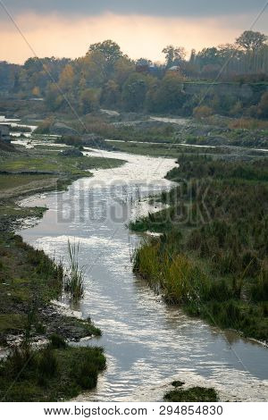 The River In The Village Flowing Along The Channel