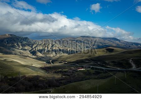 The Road Goes Up Between Hills, Mountains And Plains.