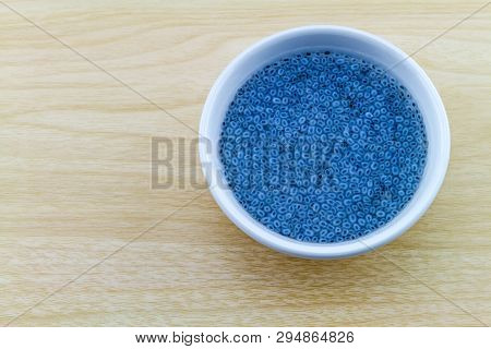 Sweet Basil In White Cup On Wooden Background.