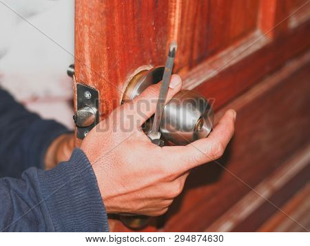 On Selective Focus At  Latch Of The Old Bathroom Door Latch Repair Technicians, By Replacing The Fau