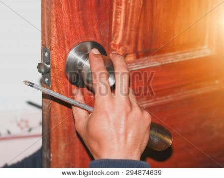 On Selective Focus At  Latch Of The Old Bathroom Door Latch Repair Technicians, By Replacing The Fau