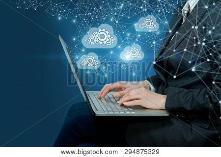 A Businesswoman Is Sitting With Notebook On Her Laps Operating With The Information Storage Working 
