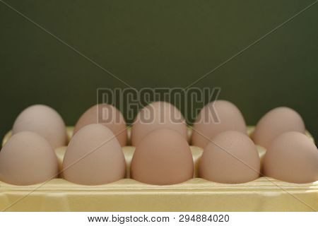 Chicken Eggs Lie In A Yellow Plastic Tray.