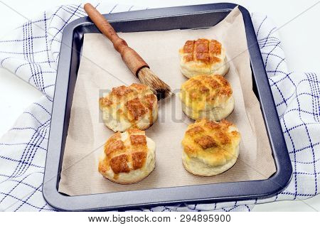 Hungarian Traditional Cheese Pogacsa With Paper On A Baking Tray