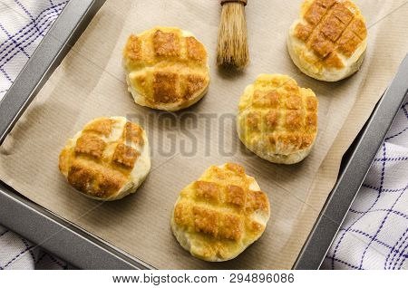 Hungarian Traditional Cheese Pogacsa With Paper On A Baking Tray
