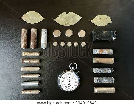 Corrosion-free Batteries.  Different Size And Shape. A Broken Stopwatch And Dry Leaves. Recycling An