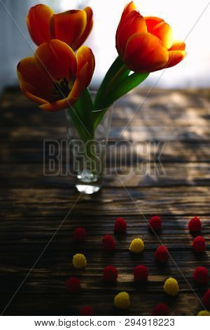 Blossoming Red Tulips On A Wooden Background With Sweets