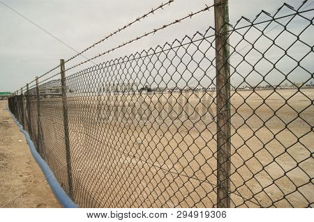 Fence Of The Chain-link In The Desert. Fencing From Thieves In The Field
