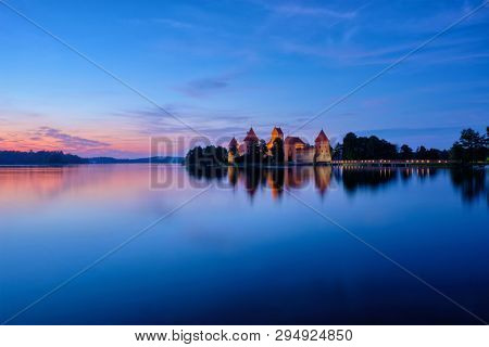 Trakai Island Castle in lake Galve illuminated in night, Lithuania